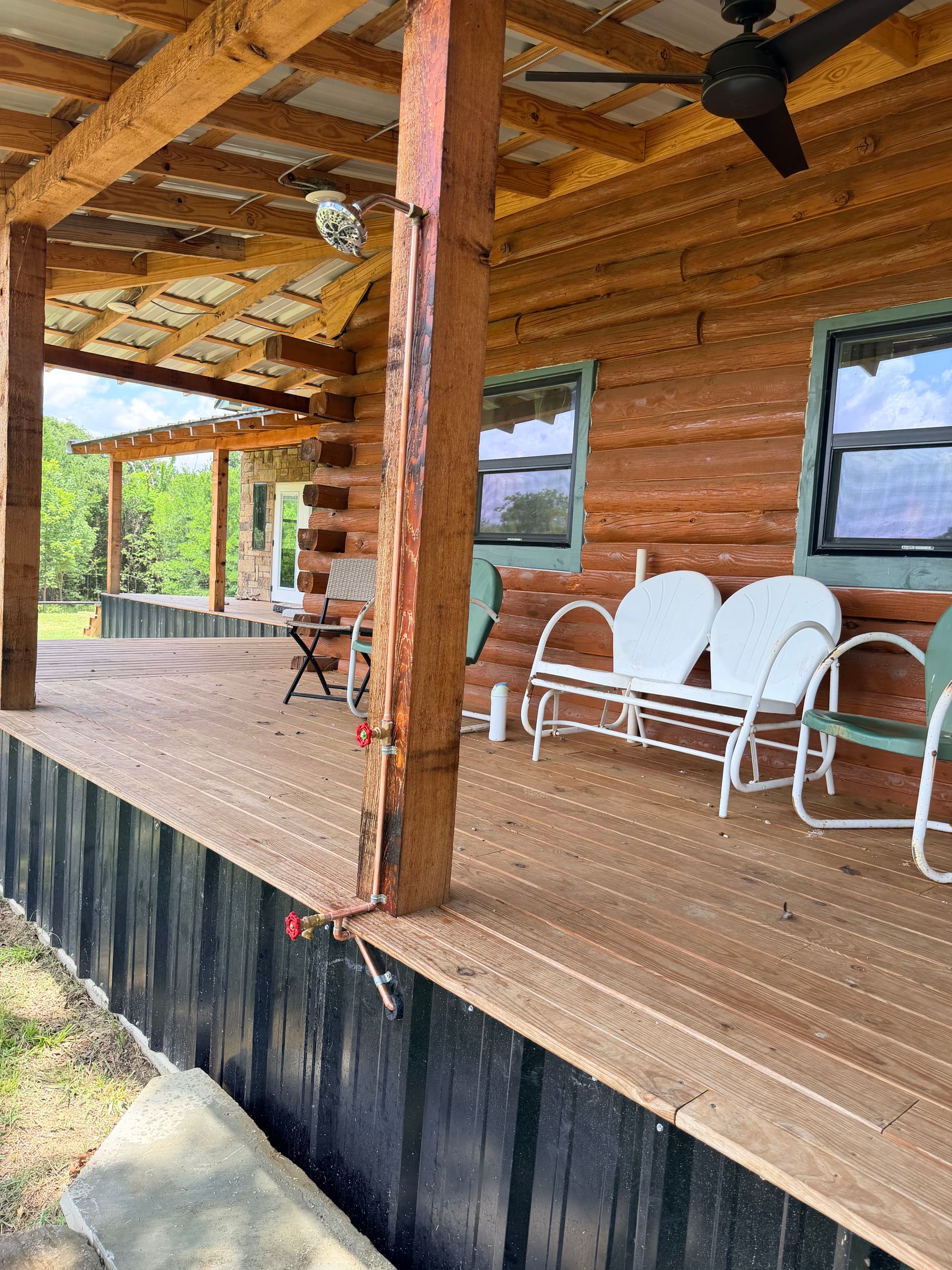 Custom Copper Outdoor Shower with Foot Wash on a Log Cabin Porch image